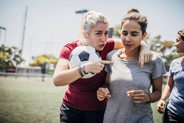 Women enjoying time together outdoors on soccer field Group of women, female soccer players, enjoying time together outdoors on soccer field. football player girlfriend stock pictures, royalty-free photos & images