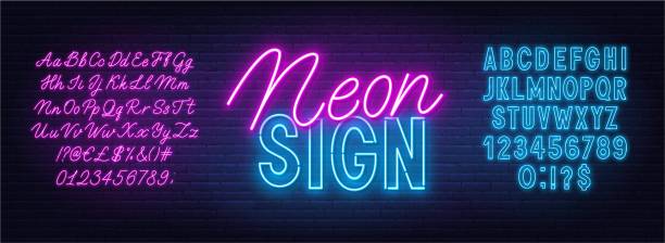 neon duo růžové a modré písmo. tučné písmo a abeceda skriptu na pozadí cihlové zdi. - neonová světla stock ilustrace