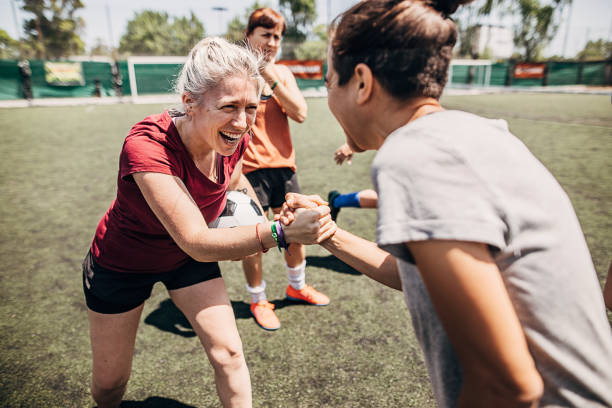 istock Two women handshake outdoors on a soccer field 1254786886
