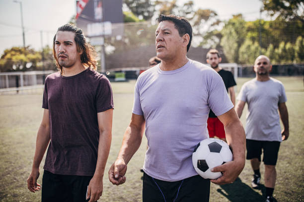 istock Soccer players standing outdoors on soccer field 1254787713