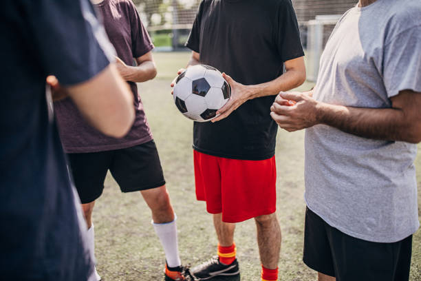 istock Soccer players standing on soccer field 1254787740