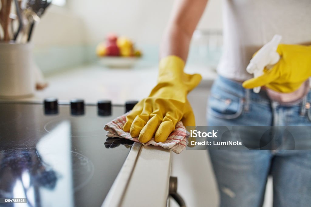 Forget sweet, try "Home sanitised home" Cropped shot of a woman cleaning a kitchen counter at home Cleaning Stock Photo