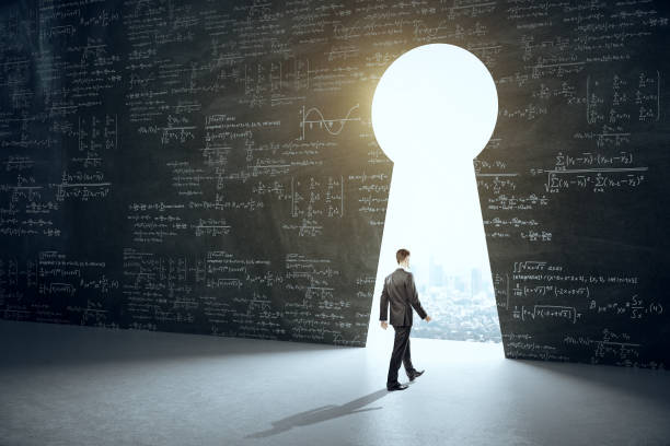 istock Businessman walking to keyhole with drawing mathematical formulas 1254789508