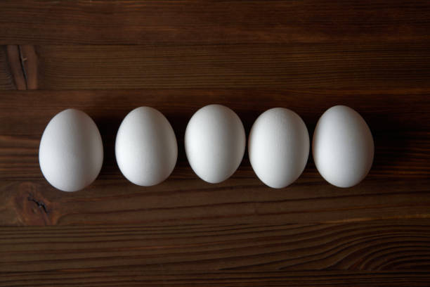 istock Eggs on wooden background. View from above. 1254790859