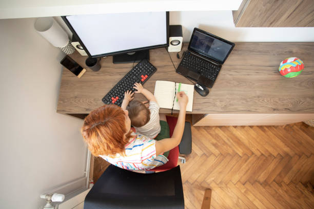 istock Overhead view of working mom 1254791132