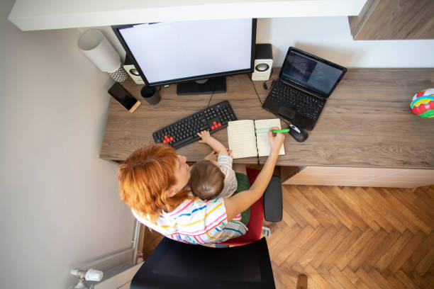 istock Overhead view of multi tasking mother 1254791133