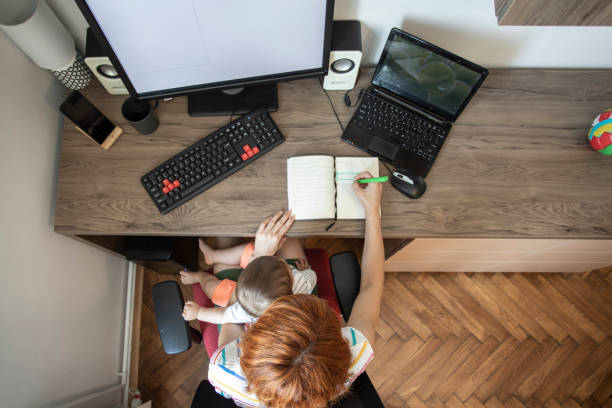istock Overhead view of multi tasking mother 1254791136