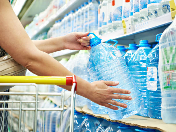 istock Drinking water in hands at shop 1254791295