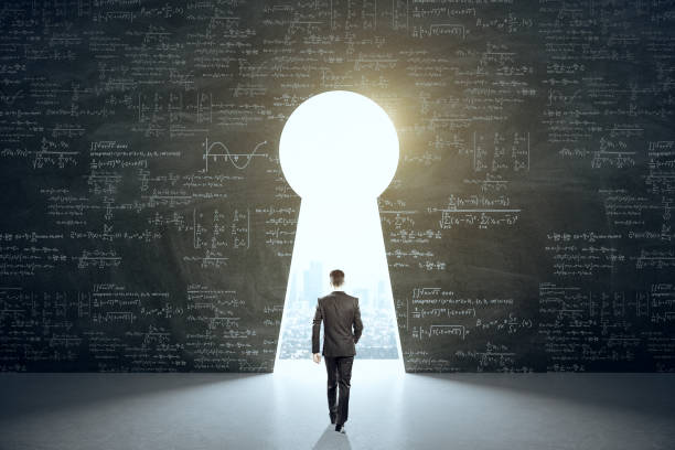 istock Businessman in suit walking to keyhole with drawing mathematical formula 1254792433