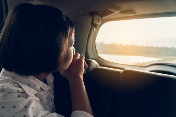 istock Girl Looking Through Window While Sitting In Car 1254792492