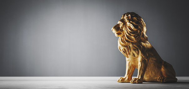 Golden statue of lion, a sculpture. Concept of a strength power and staying proud. 3D illustration