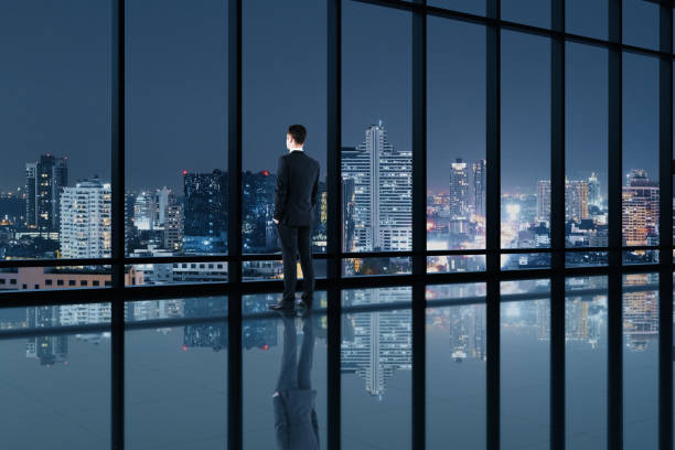 istock Businessman standing in contemporary office interior 1254794007