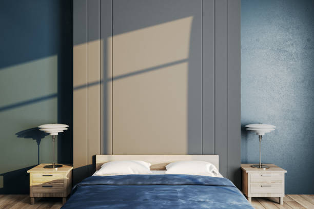 istock Contemporary bedroom with blue cover and copy space wall. 1254794120