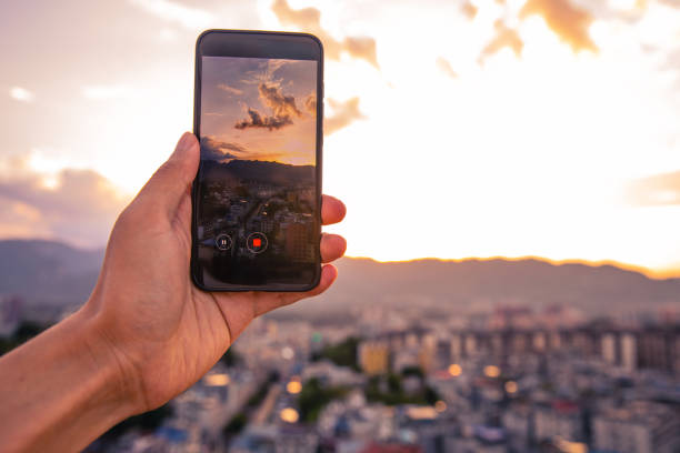 istock Filming city sunset with mobile phone 1254796524
