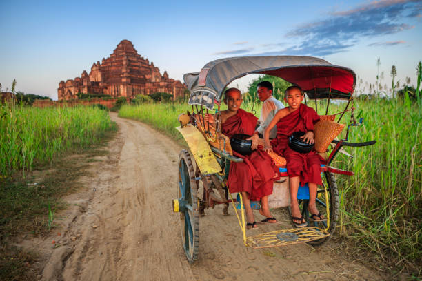 istock Young Buddhist monks on the horse cart 1254797748