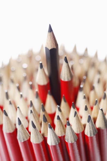 istock Blue pencil among bunch of red pencils 1254798207