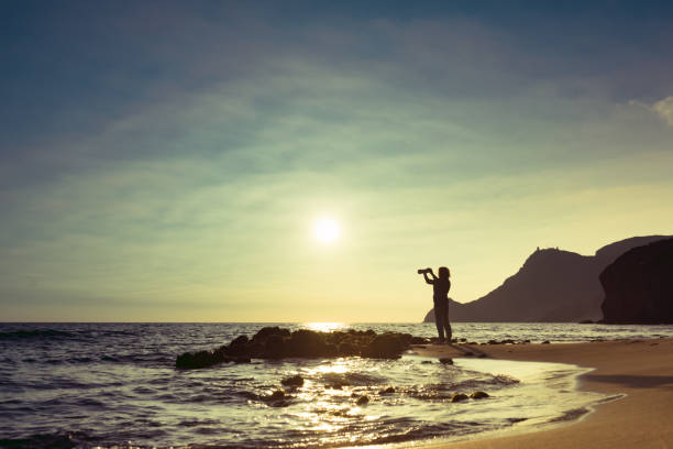 istock Woman with camera on Monsul beach, Spain 1254799427