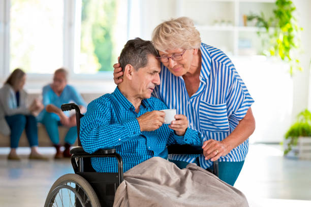 istock Elderly lady consoling senior man 1254799553