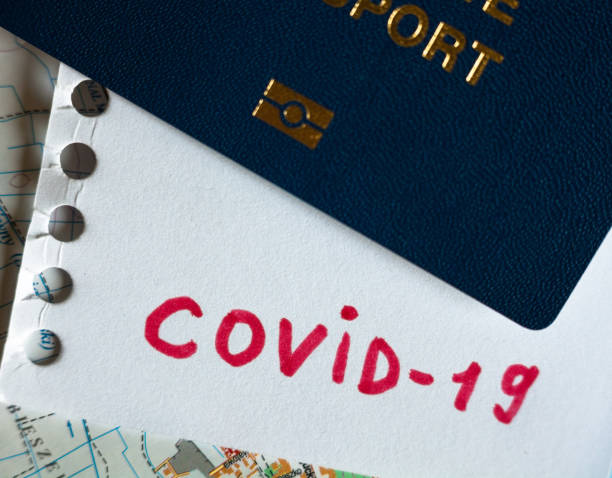 istock Passport and note with Covid-19 inscription. 1254799554