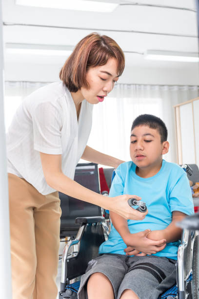 istock woman exercise via hand gripper with disabled child 1254799599