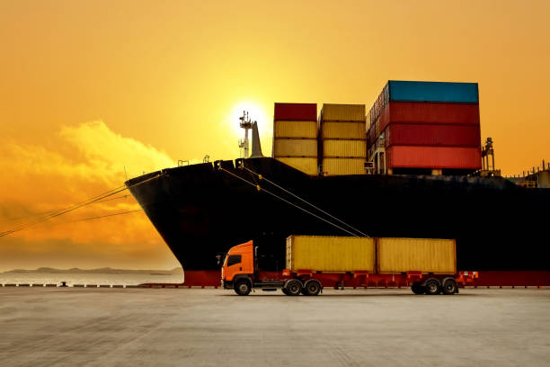 istock Huge container vessel discharging and loading container cargo at port terminal. Quay crane pick up container from truck onto ship. 1254799765
