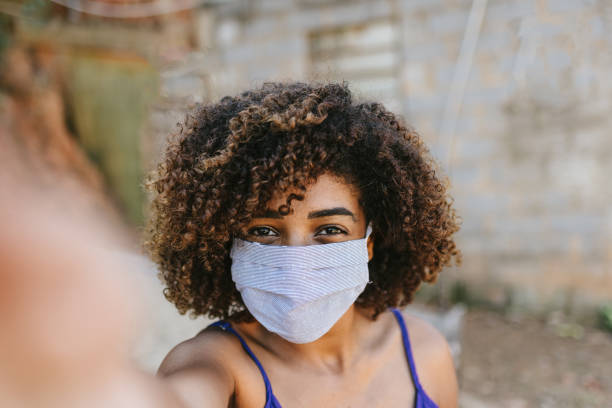 istock Covid-19: Young woman taking a selfie wearing a mask 1254800302