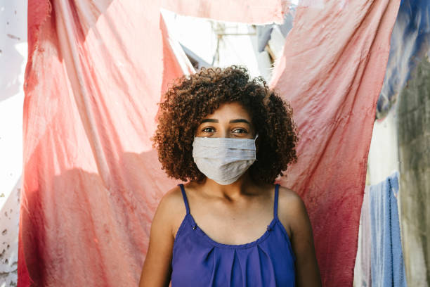 istock Covid-19: Girl wearing a mask in her community 1254800328