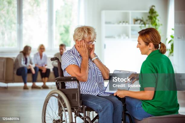 Home Nurese Discussing Medical Test Results With Senior Woman Stock Photo - Download Image Now