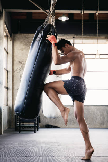 istock Muaythai kickboxing of punching bag. 1254801194