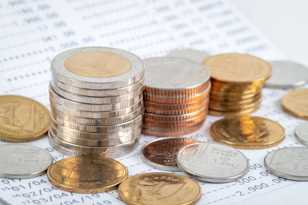 istock Coins stack on bank account book, growing money saving concept 1254804427