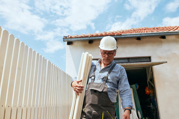 Construction worker carrying white wooden planks
