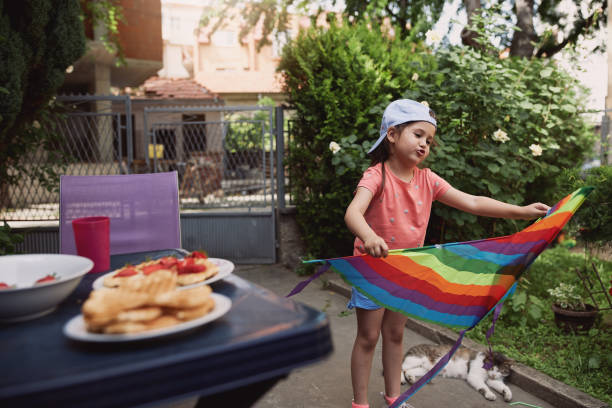 istock Playful girl having fun in her backyard with a kite 1254805168