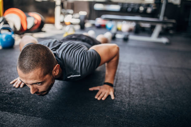 istock Determined young athlete doing push ups in the gym 1254805193