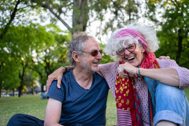 istock Joyful senior couple laughing in a public park 1254805219