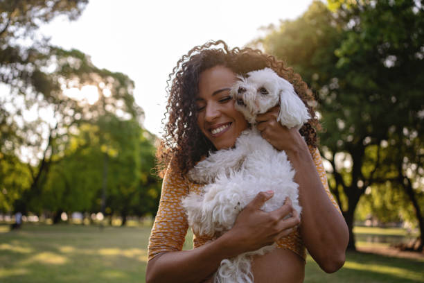 istock Woman showing affection towards her little white dog 1254805245