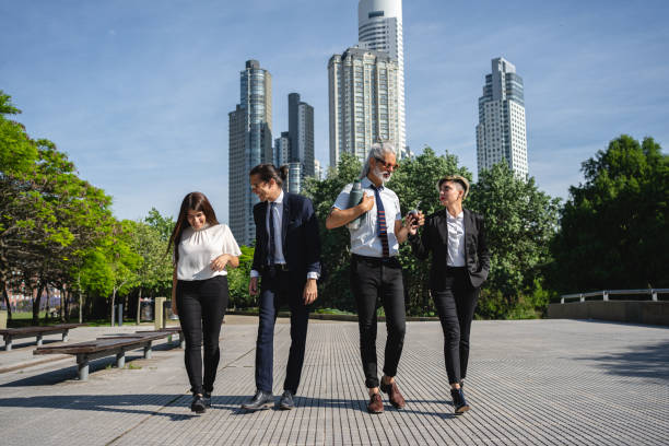 istock Business team walking through a public park together 1254805307
