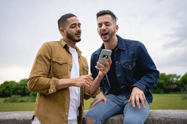 istock Homosexual couple surfing the web on a mobile phone together 1254805675