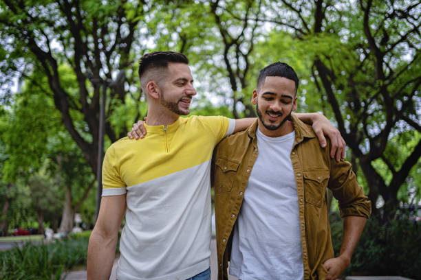 istock Gay couple enjoying a walk in a public park 1254805708