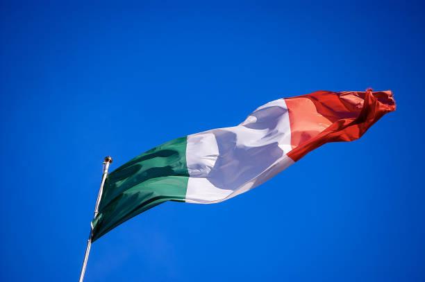 istock Italian flag waving in the clear blue sky - Bottom view 1254806866