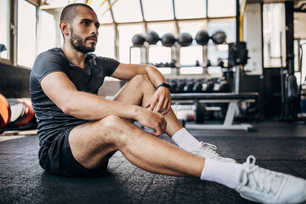 istock Young man taking a break after training in the gym 1254806980