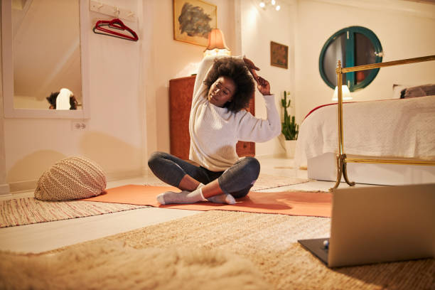 istock Black woman stretching before getting to work at home 1254808463