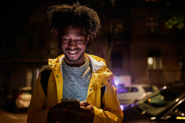 istock Black tourist looking at an online map while exploring at night 1254808479
