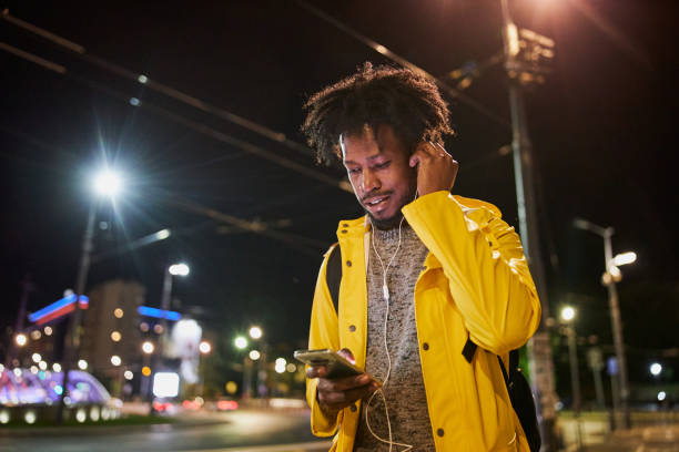 istock Black man enjoying a walk outdoors at night while listening to music 1254808502