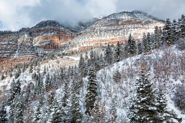 Storm clouds lift to reveal a beautifu, fresh coating of snow in Ouray Colorado.