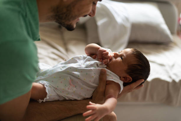 istock Father holding newborn baby 1254810363