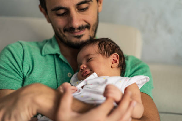 istock Father holding newborn baby 1254810414