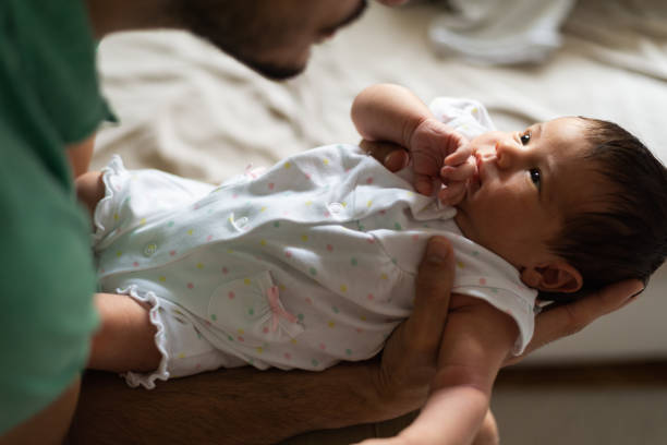 istock Father holding newborn baby 1254810551
