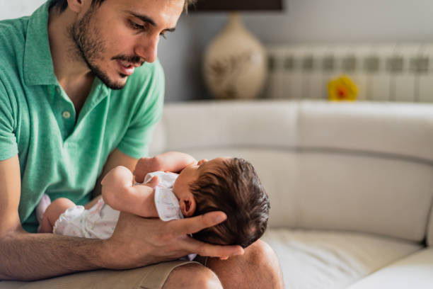 istock Father holding newborn baby 1254810659