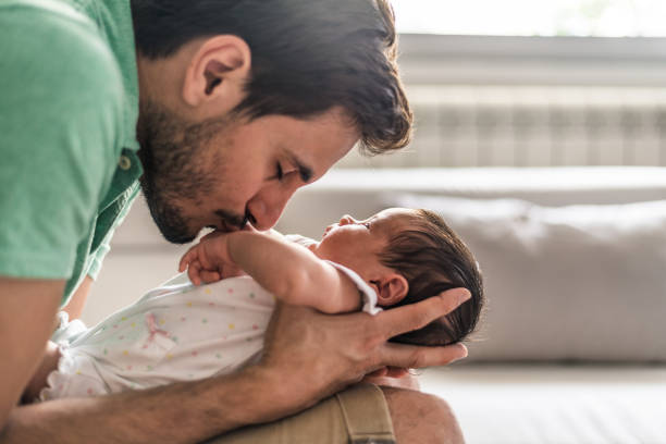 istock Father holding newborn baby 1254810713