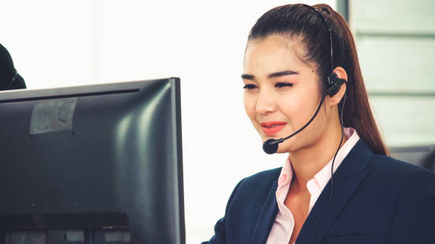 istock Business people wearing headset working in office 1254811773